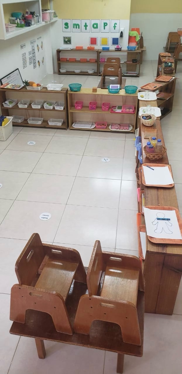 Montessori materials on low shelves in the Toddler Community — practical life and sensorial work